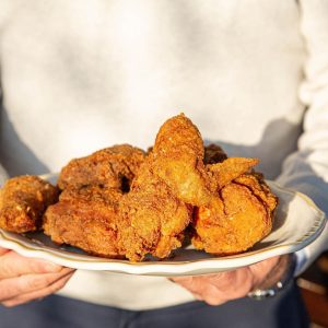 a person holding a plate of food a person holding a plate of food